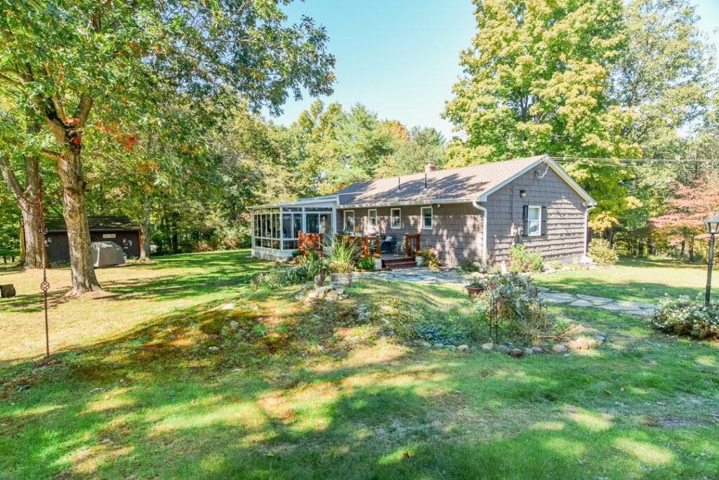 Back view at 342 Round Lake Rd, showing sunroom